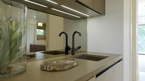Cozy bathroom interior with focus on sleek sink area. Black faucet and large Stock Footage 275825344