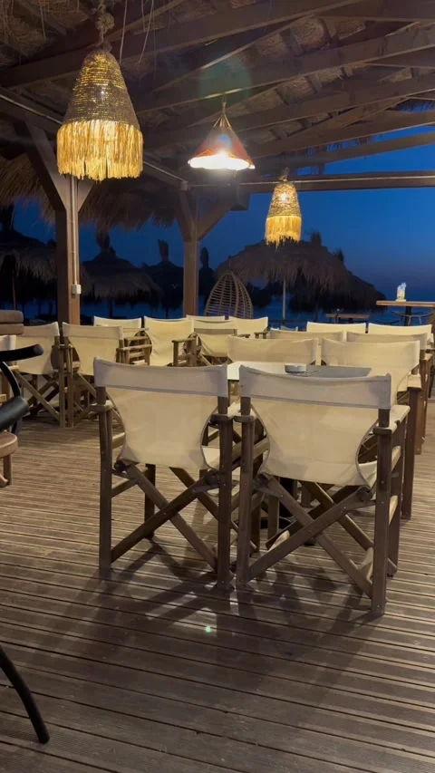 Cozy Beach Cafe Deck with Woven Pendant Lights in Golem Albania at Dusk Stock Footage 343392174