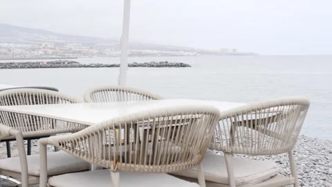 Cozy Beachfront Dining Area with Elegant Rattan Furniture Stock Footage 316666349