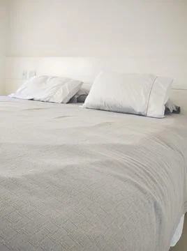 Cozy bed in a clean environment Stock Photos