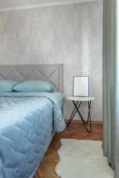 Cozy Bedroom Corner with Bedside Table and Mockup Frame Stock Photos