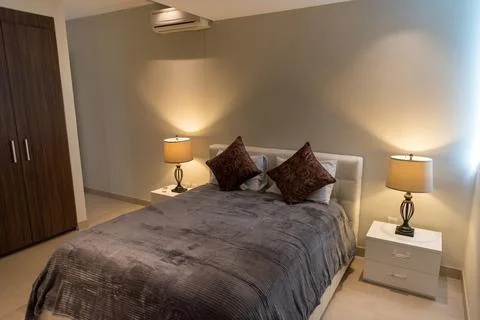 Cozy bedroom lighting with bedside table lamps Stock Photos