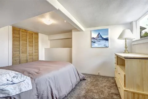 Cozy bedroom with low ceiling Stock Photos