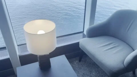 Cozy Boat Interior with Decorative Lamp, Sofa and Water View Through Window Stock Footage 340106429