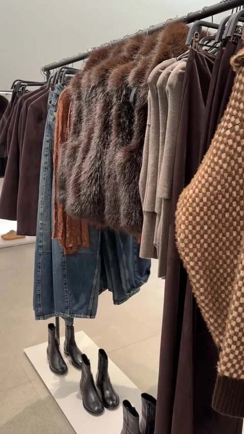 Cozy Brown Patterned Knitwear Hanging In Contemporary Fashion Boutique Vídeos de archivo 337193563