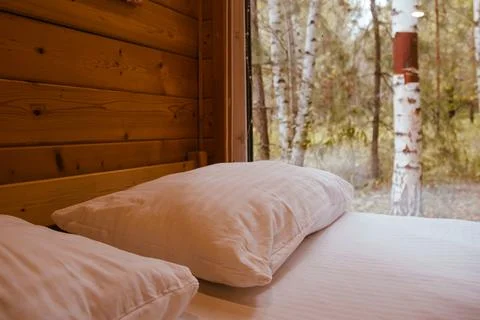 Cozy Cabin Bedroom with Forest View Through Large Window Stock Photos