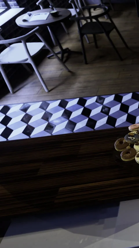Cozy cafe corner with unique tile design and tempting pastries on display Stock Footage 331691830