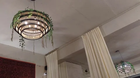 Cozy Cafe Interior with Brick Wall, Hanging Lamps, and Mosaic Window 4k Stock Footage 302881249