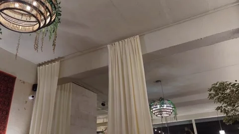 Cozy Cafe Interior with Brick Wall, Hanging Lamps, and Mosaic Window Stock Footage 302881252