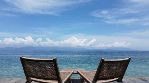 Cozy cafe stools with ocean and mountain view in sunny weather. Calm, peaceful, Stock Footage 238581589