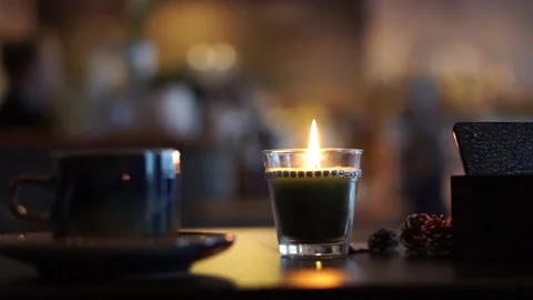 Cozy cafe table with candle and cup of tea / coffee FULL HD Video Video stock 145487604