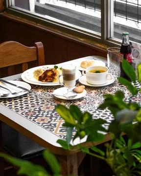 Cozy cafe table with patterned tile surface 库存照片