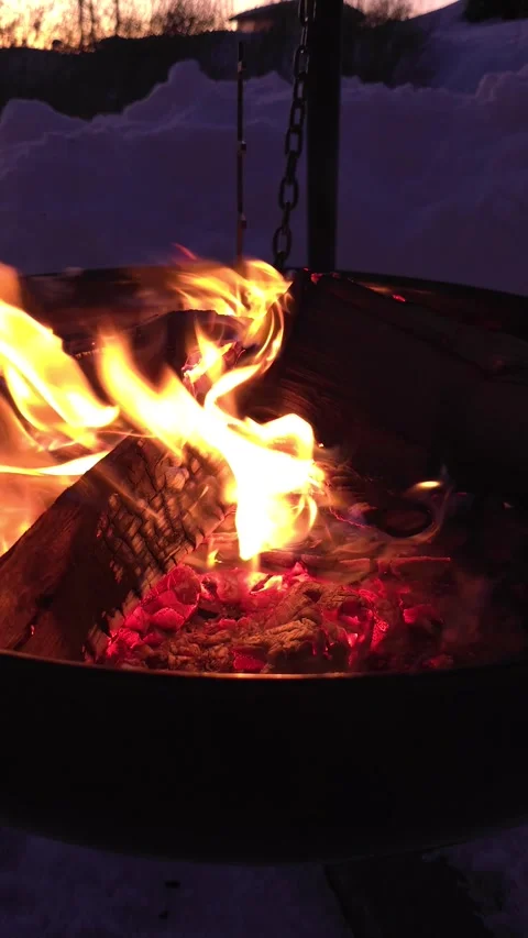 Cozy Campfire with Glowing Embers in Winter Twilight Stock Footage 302544441
