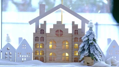 Cozy Christmas decor tiny house of small size on window sill with snow outs.. Video stock 262364267
