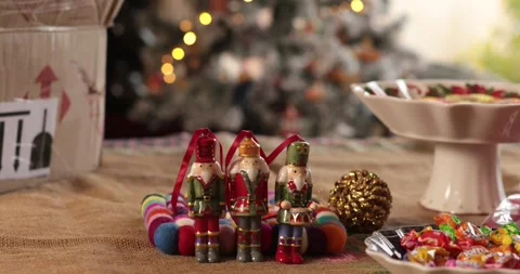 Cozy Christmas decorations with nutcracker figurines and colorful treats Video stock 311936207