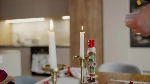 Cozy Christmas Dinner Setting with Lit Candles and Festive Decor Stock Footage 344270590