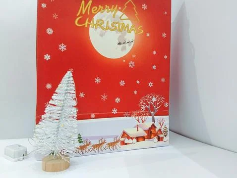 A Cozy Christmas Scene: Mini Tree and Festive Card Stock Photos