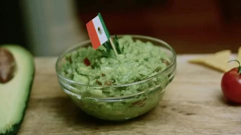 Cozy closeup composition of tortilla chips arranged around guacamole Stock Photos