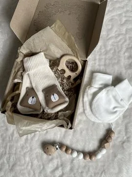 Cozy clothes and accessories for caring for a newborn in pastel colors in a.. Stock Photos