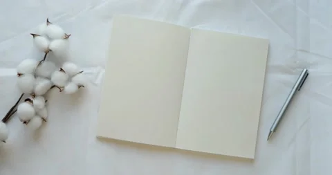 Cozy composition with a clean opened note, pen and cotton on a white sheet Stock Footage 226944506