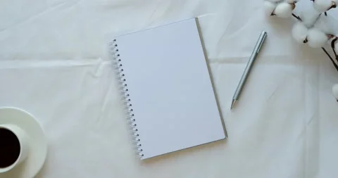 Cozy composition with a clean opened note, cup of coffee, pen and cotton branch Stock Footage 226945436