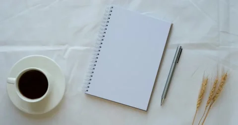 Cozy composition with a clean opened note, cup of coffee, pen and a wheat ears Stock Footage 226947166