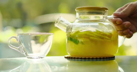 Cozy day. Pouring fruit tea. Slow motion Stock Footage 225303014