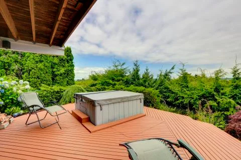 Cozy deck with jacuzzi overlooking scenic nature Stock Photos