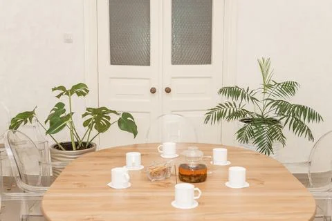 Cozy dining setting featuring a round wooden table surrounded by transparent Stock Photos