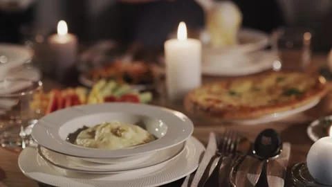 Cozy dinner table set for holiday celebration with warm candle glow creatin.. Stock Footage 335052827