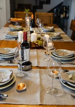Cozy dinner table setting with wine and candles Foto stock