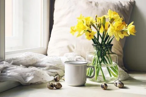 Cozy Easter, spring still life scene. Mug of coffee, wooden plate, quail eggs Fotos Stock