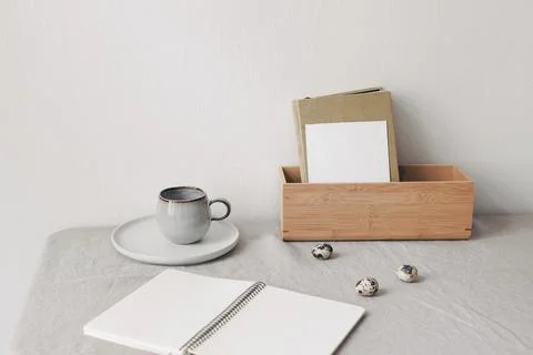 Cozy Easter, spring still life scene with blank notepad mockup. Cup of coffee 写真素材
