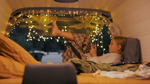 Cozy evening in a van with string lights and relaxation in nature Stock Footage 308230526