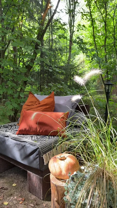 Cozy fall outdoor lounge with pumpkin decor in woodland garden Stock-Footage 342648446