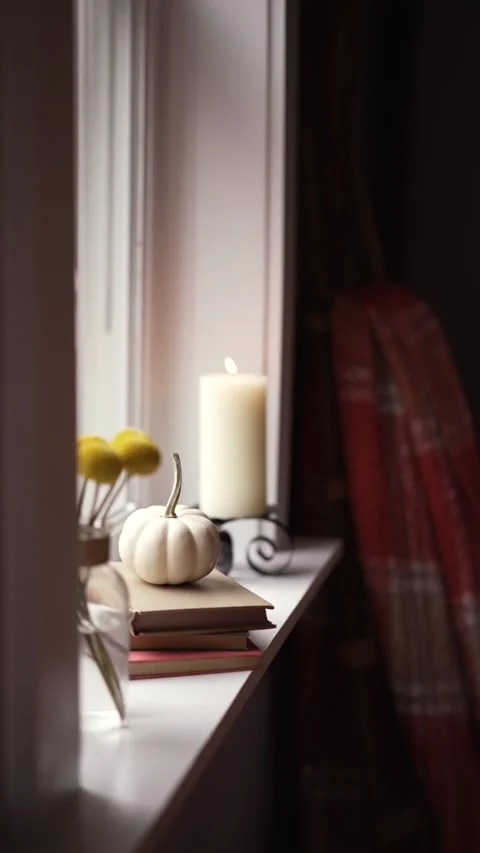 Cozy fall window with pumpkin, florals and a candle Stock Footage 218266891