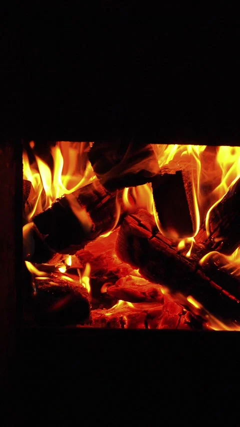 Cozy fire burning brightly in fireplace Video stock 337887944