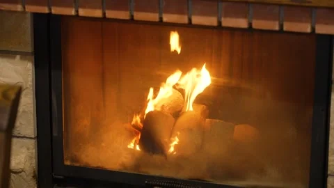 Cozy fireplace heating a home with burning fire logs and warm comforting flames Stock Footage 341868961