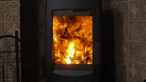 Cozy flames dancing in a modern fireplace during a winter evening indoors Stock Footage 295876746