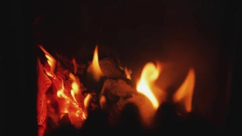 Cozy Flames in a Fireplace Providing both Warmth and Light for a Welcoming Stock Footage 321947691
