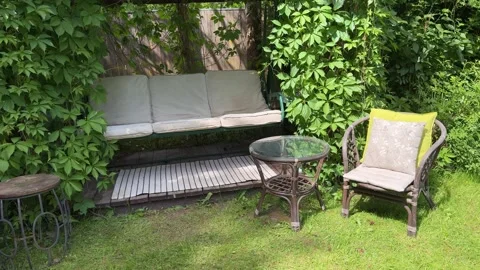 Cozy Garden Swing Seating Area Under Lush Grapevine Pergola 動画素材 336600761