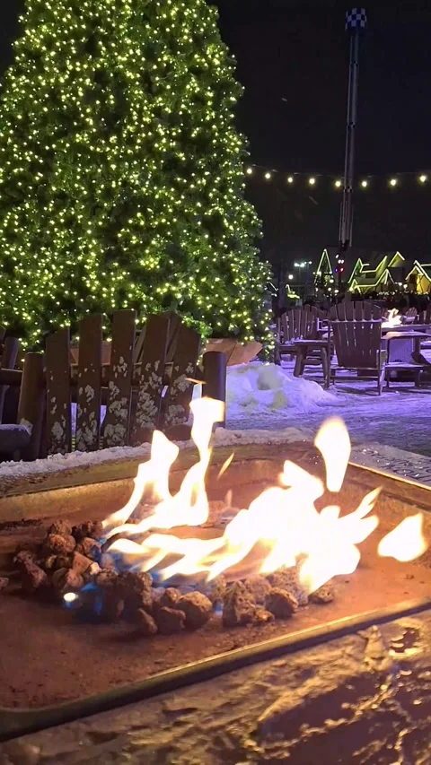 Cozy gas fire pit burning at a winter Christmas market Stock Footage 326168386