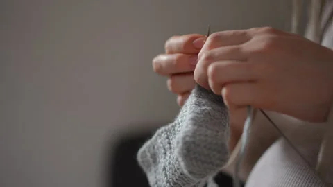 Cozy Hand Knitting Engaging in the Craft of Creating Soft Gray Sock for Comfort Stock Footage 283900565