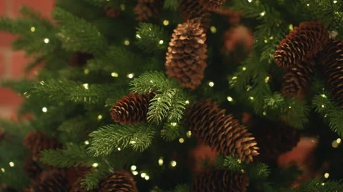 Cozy holiday setting with illuminated pinecones. Intimate festive scene Stock Footage 345172650