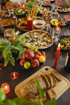 Cozy holiday table setting with different delicious food and beverages ready for Stock Photos