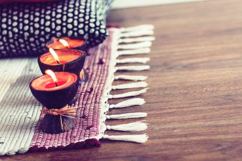 Cozy home interior decor background, burning candles in coconut shell on a mu Stock Photos