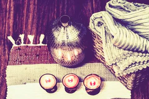 Cozy home interior decor, burning candles on a multi-colored rug on the backg Stock Photos
