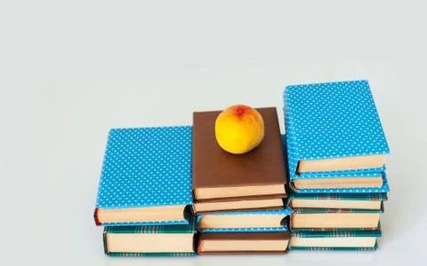 Cozy home interior decor: stack of books and vase with yellow flowers on a ta Stock Photos