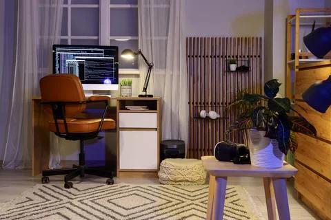 Cozy home office setup with computer and plants Stock Photos