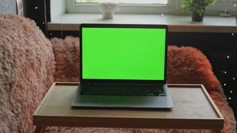 Cozy home office setup with a laptop on a tray table and fluffy blanket Stock Footage 340265137